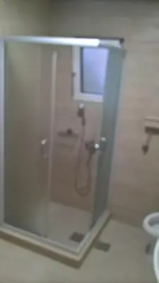 a shower with a glass door in a bathroom at Djurdja 2 Apartman in Arandjelovac