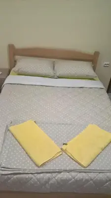 a bed with two yellow napkins on top of it at Djurdja 2 Apartman in Arandjelovac