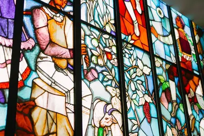 a stained glass window with a group of people at Metropol Palace, Belgrade in Belgrade