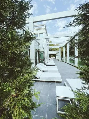 an external view of a white house with trees at Metropol Palace, Belgrade in Belgrade