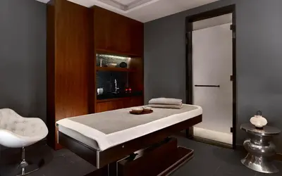 a room with a bed and a chair in it at Metropol Palace, Belgrade in Belgrade