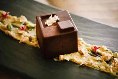 a chocolate bar on top of a slice of pizza at Metropol Palace, Belgrade in Belgrade