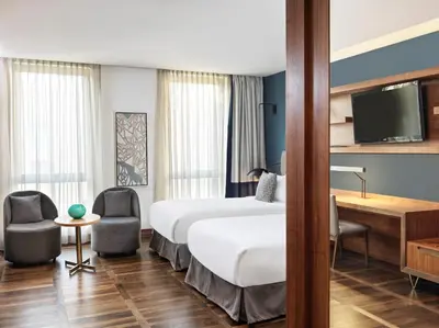 a hotel room with a bed and a tv at Metropol Palace, Belgrade in Belgrade