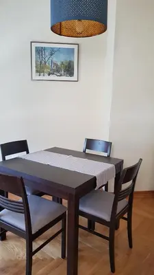 a dining room table with chairs and a blue light at Gundulic in Belgrade