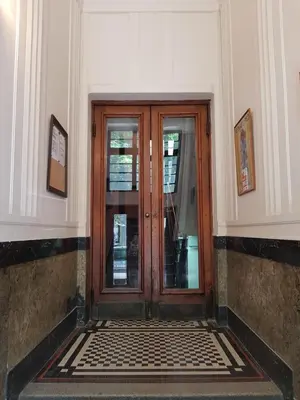 a wooden door in a building with a tile floor at Gundulic in Belgrade