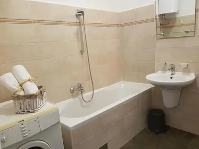 a bathroom with a sink and a tub and a toilet at Gundulic in Belgrade