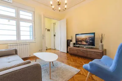 a living room with a couch and a tv at Gundulic in Belgrade