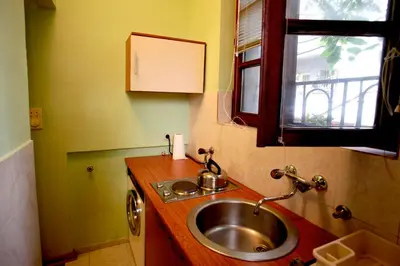 a small bathroom with a sink and a window at Studio Hram 2 in Belgrade