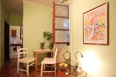 a room with a table and two chairs and a window at Studio Hram 2 in Belgrade
