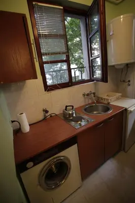 a kitchen with a washing machine and a sink at Studio Hram 2 in Belgrade