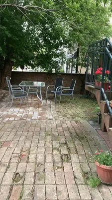 a patio with chairs and a table and a fence at Studio Hram 2 in Belgrade