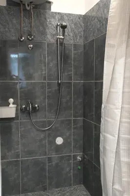 a bathroom with a shower with a shower curtain at Apartment Petra 072 in Belgrade