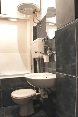 a bathroom with a toilet and a sink and a mirror at Apartment Petra 072 in Belgrade