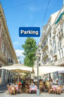 a street with tables and umbrellas in a city at Apartment Petra 072 in Belgrade