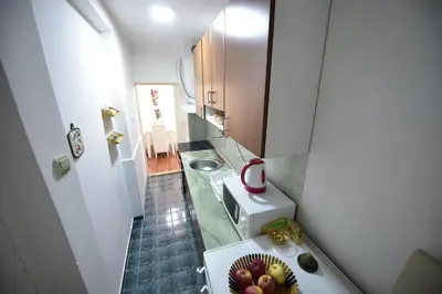 a small bathroom with a sink and a bowl of fruit at Beograd - apartman 