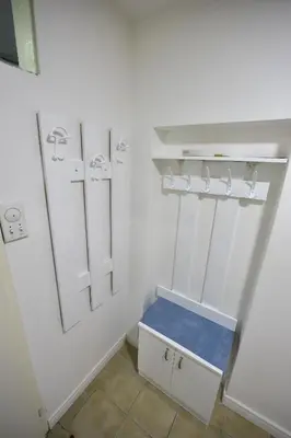 a bathroom with white walls and a blue bench at Beograd - apartman 