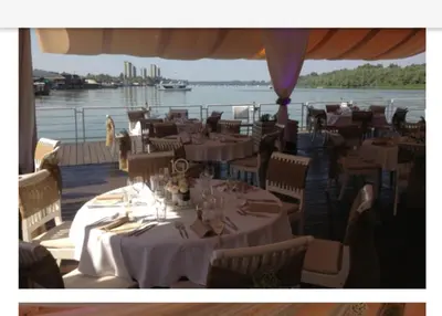 a restaurant on a boat with tables and chairs at Beograd - apartman 