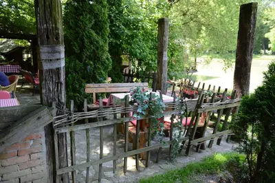 a wooden fence in a garden with a table and chairs at Principessa Apartment in Belgrade