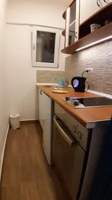 a small kitchen with a sink and a stove at Azzurro Studio Apartment in Belgrade