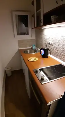 a kitchen counter with a sink and a stove at Azzurro Studio Apartment in Belgrade
