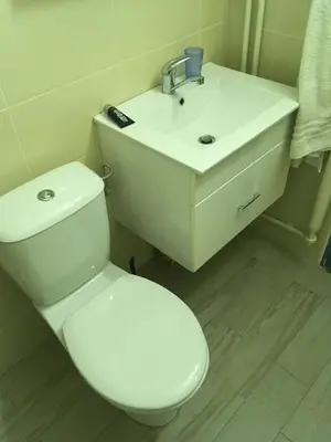 a bathroom with a white toilet and a sink at Azzurro Studio Apartment in Belgrade