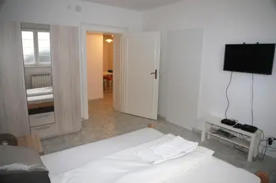 a bedroom with a bed and a flat screen tv at Petars Apartment in Belgrade