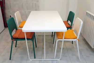 a white table and chairs in a room at Petars Apartment in Belgrade