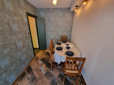 a dining room with a table and some chairs at King Marko Apartment (65m2) in Belgrade