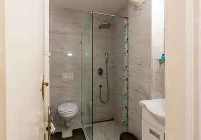 a bathroom with a shower with a toilet and a sink at King Marko Apartment (65m2) in Belgrade