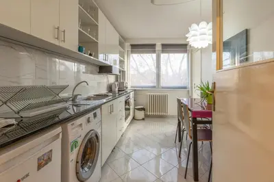 a large kitchen with a washer and dryer in it at King Marko Apartment (65m2) in Belgrade