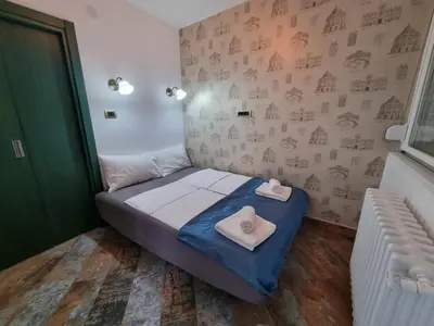 a small bedroom with a bed with towels on it at King Marko Apartment (65m2) in Belgrade