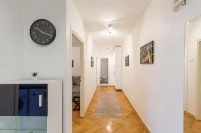 a hallway with a clock on a wall at King Marko Apartment (65m2) in Belgrade