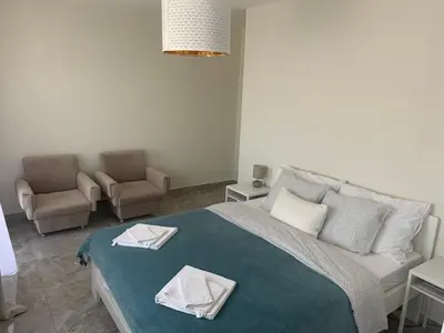 a bedroom with a bed with two towels on it at Lux House Olga in Ruma