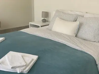 a bed with a towel sitting on top of it at Lux House Olga in Ruma