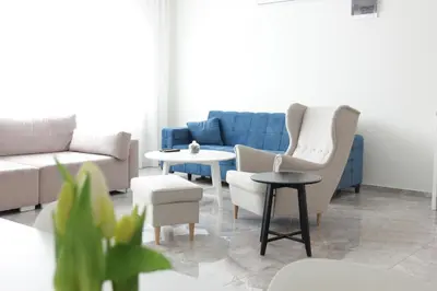 a living room with a couch and chairs and a table at Lux House Olga in Ruma