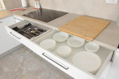a kitchen with white dishes in a drawer at Lux House Olga in Ruma