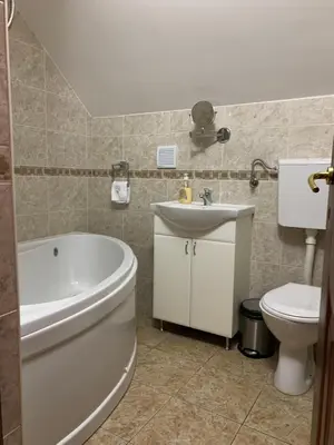 a bathroom with a tub and a toilet and a sink at Bellmatini in Belgrade