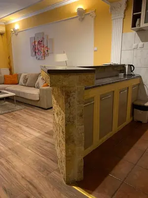 a kitchen with a stone counter top in a living room at Bellmatini in Belgrade