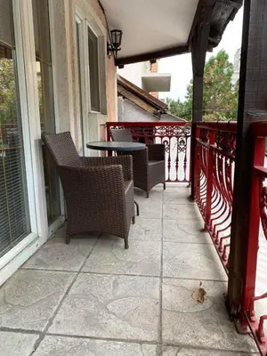 a patio with chairs and a table on a balcony at Bellmatini in Belgrade