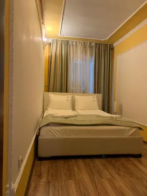 a large bed in a room with a window at Bellmatini in Belgrade