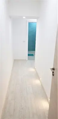 an empty room with a door and a wooden floor at Asya Studio in Belgrade