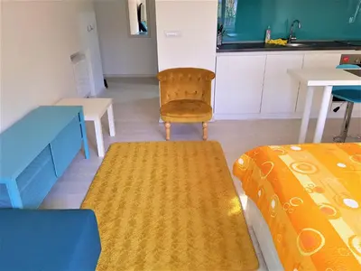 a room with two beds and a table and a chair at Asya Studio in Belgrade