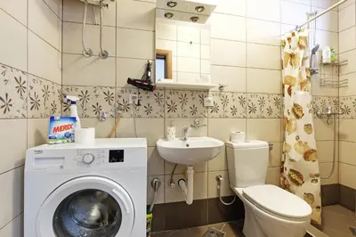 a bathroom with a washing machine and a sink at Apartment Paradise Sunny Home in Belgrade