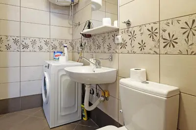 a bathroom with a sink and a toilet at Apartment Paradise Sunny Home in Belgrade