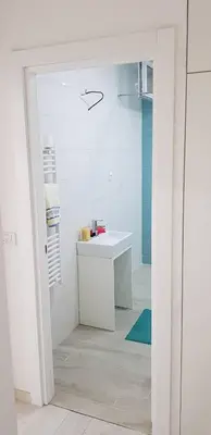 a bathroom with a white sink and a shower at Asya Blue Apartment in Belgrade