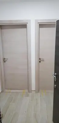 two garage doors in a room with wood floors at Asya Blue Apartment in Belgrade