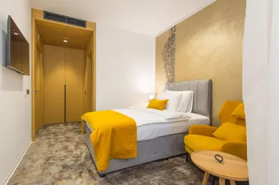 a hotel room with a bed and a couch at Boutique Hotel Museum in Belgrade