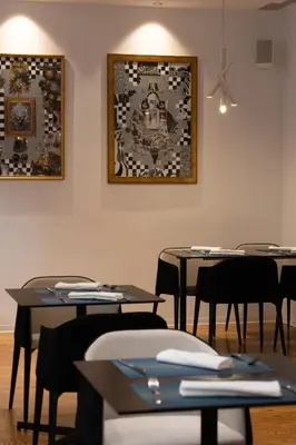 a room with tables and chairs and a picture on the wall at Boutique Hotel Museum in Belgrade