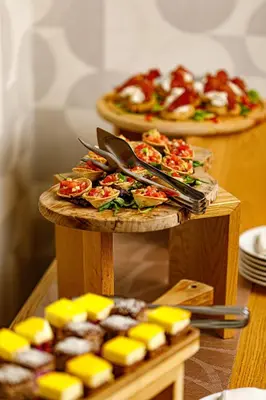 a table with two plates of food and cheese at Boutique Hotel Museum in Belgrade