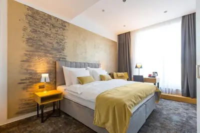 a bedroom with a large bed with a large painting on the wall at Boutique Hotel Museum in Belgrade